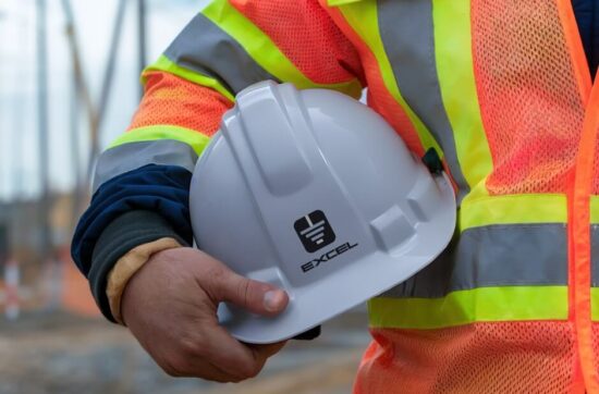 Excel Electric contractor working at Downers Grove High School, holding a hard hat